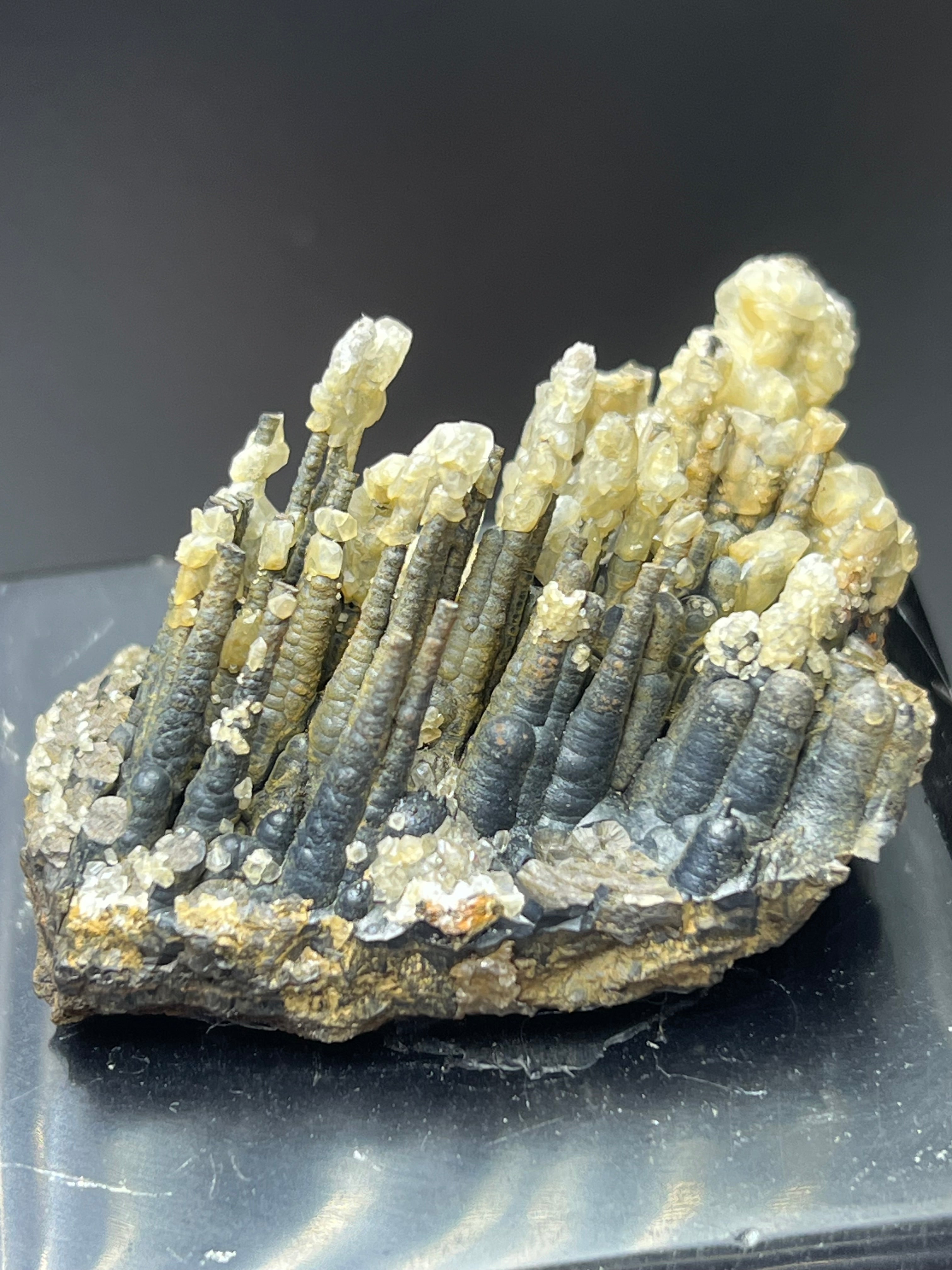 Calcite With Stalactite Goethite On Obsidian Stand