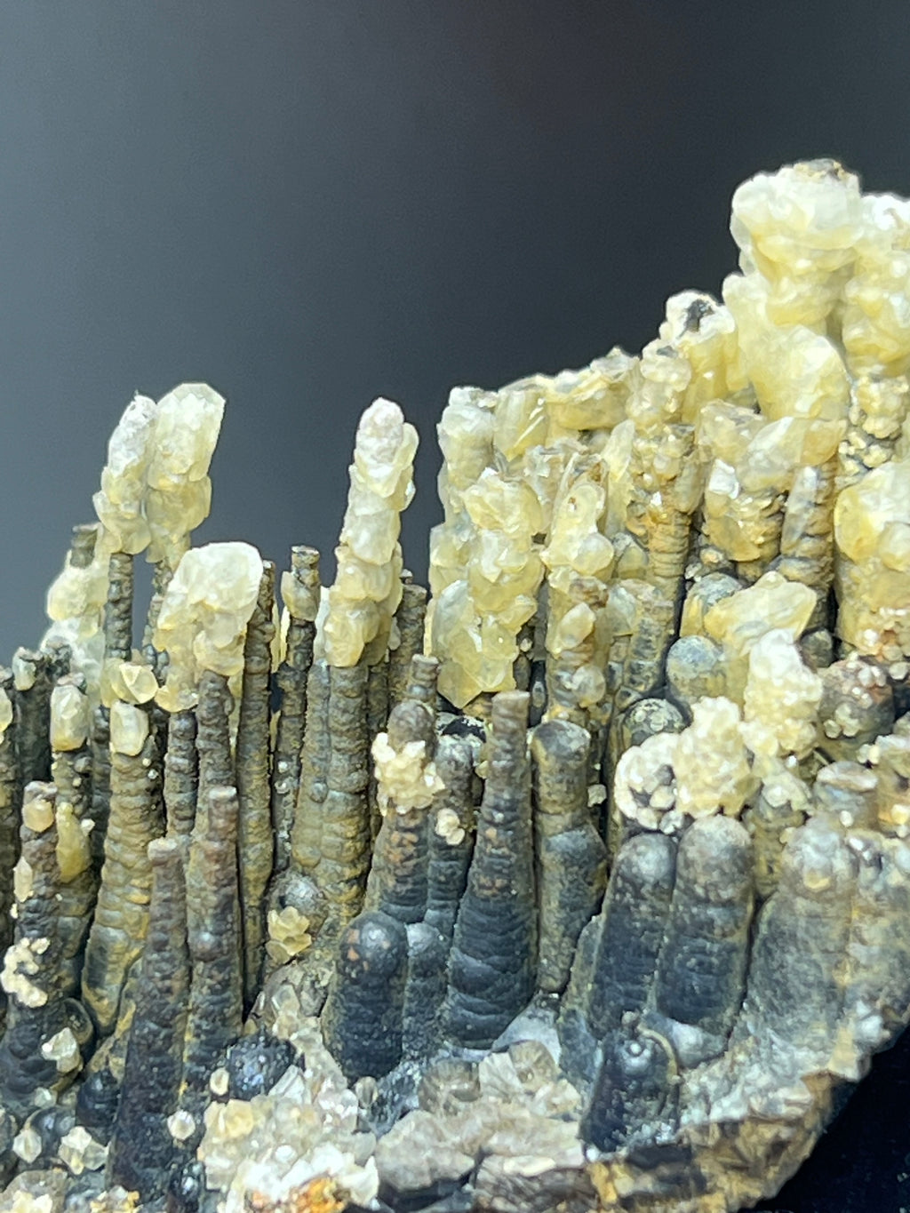 Calcite With Stalactite Goethite On Obsidian Stand
