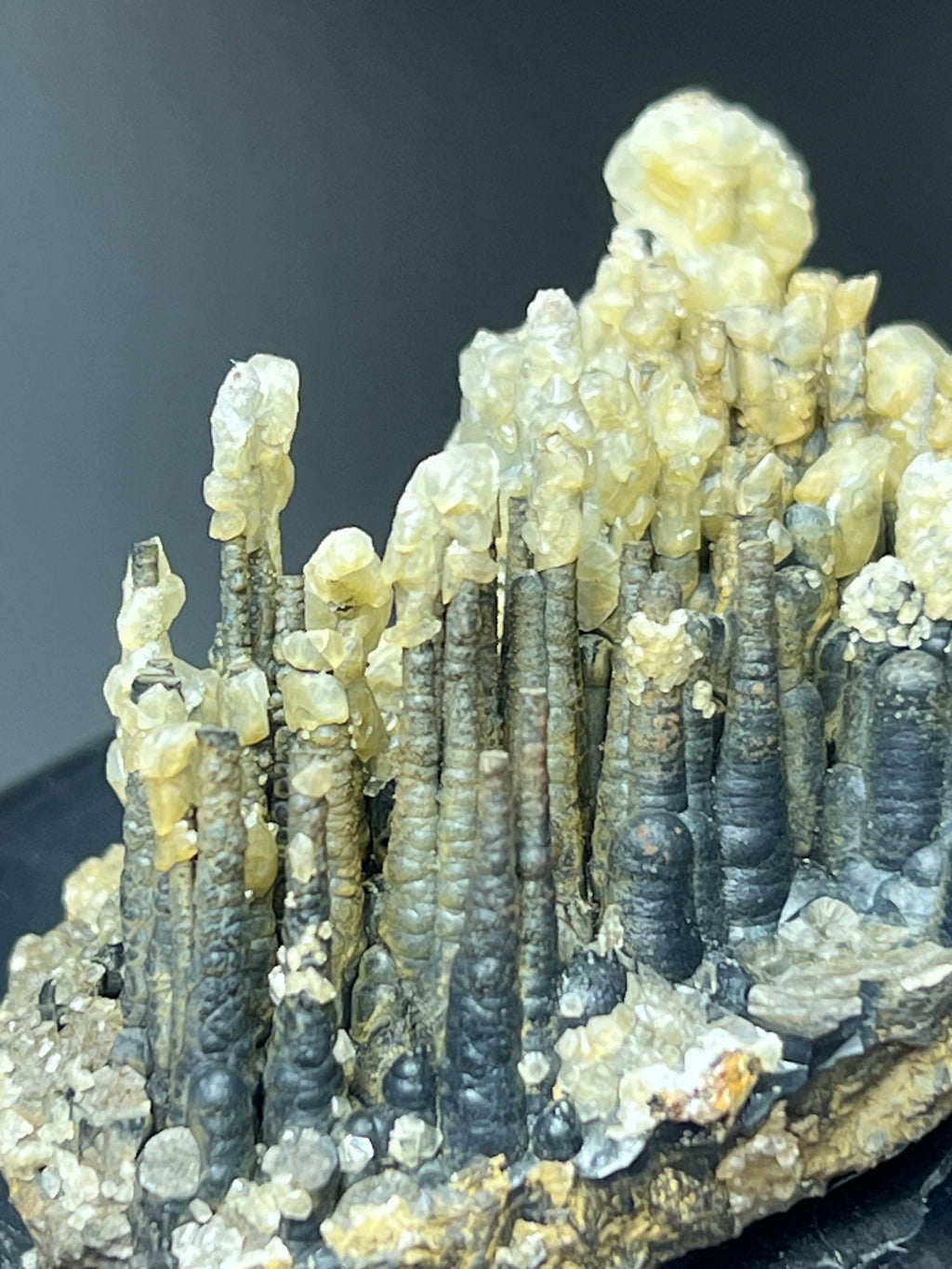 Calcite With Stalactite Goethite On Obsidian Stand